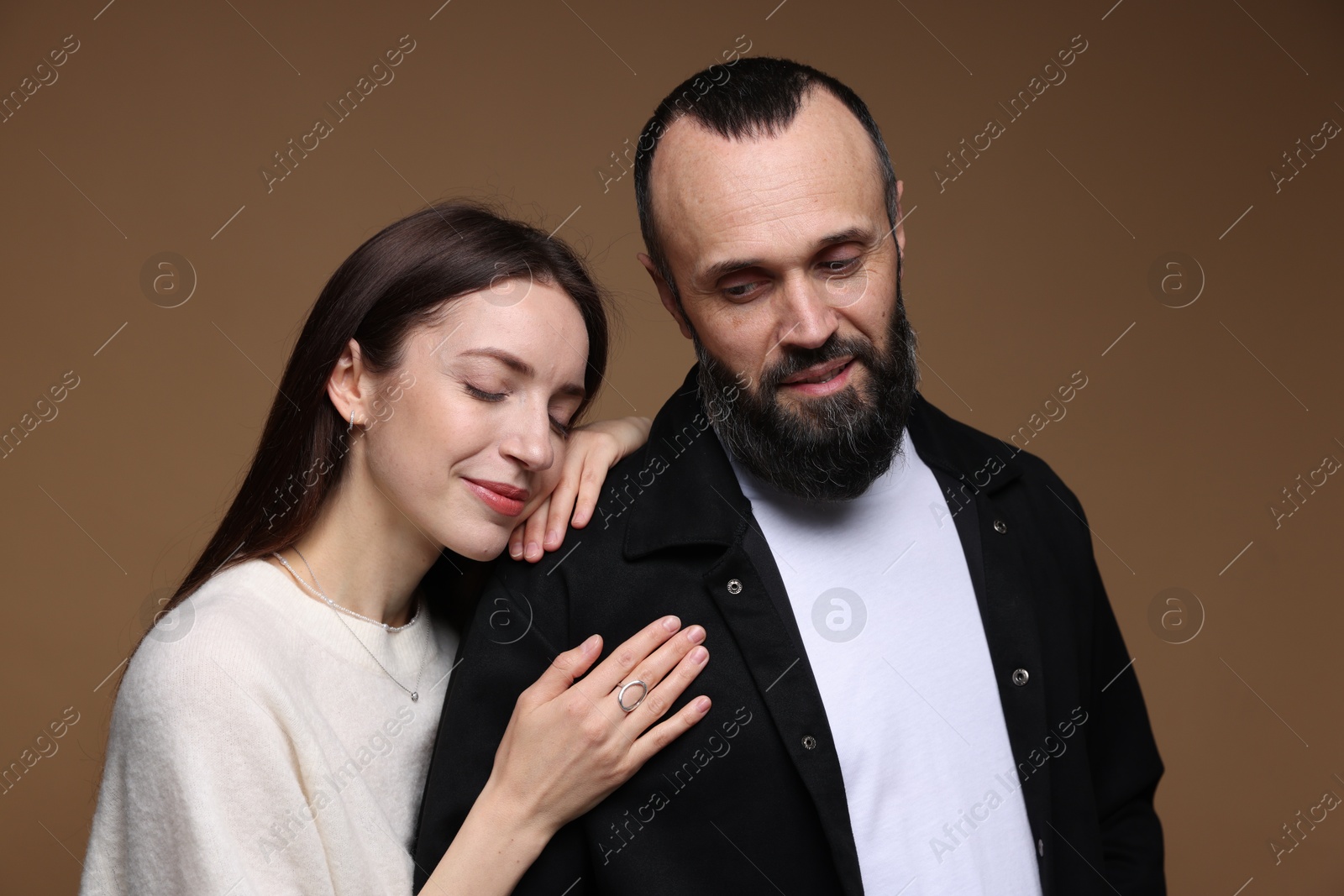 Photo of Cute daughter and father on brown background