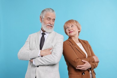 Lovely senior couple on light blue background