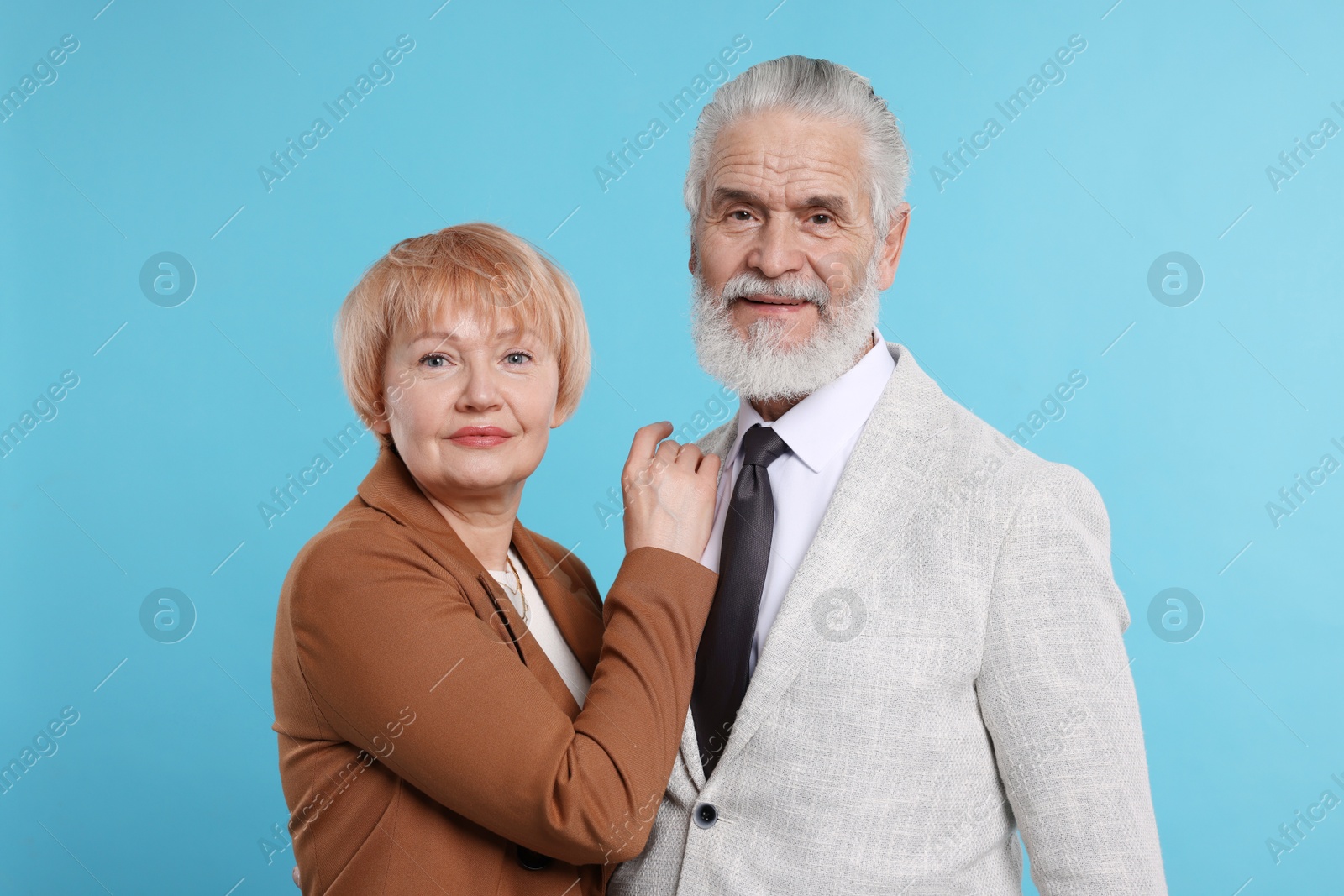 Photo of Portrait of lovely senior couple on light blue background