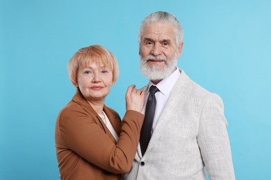 Photo of Portrait of lovely senior couple on light blue background