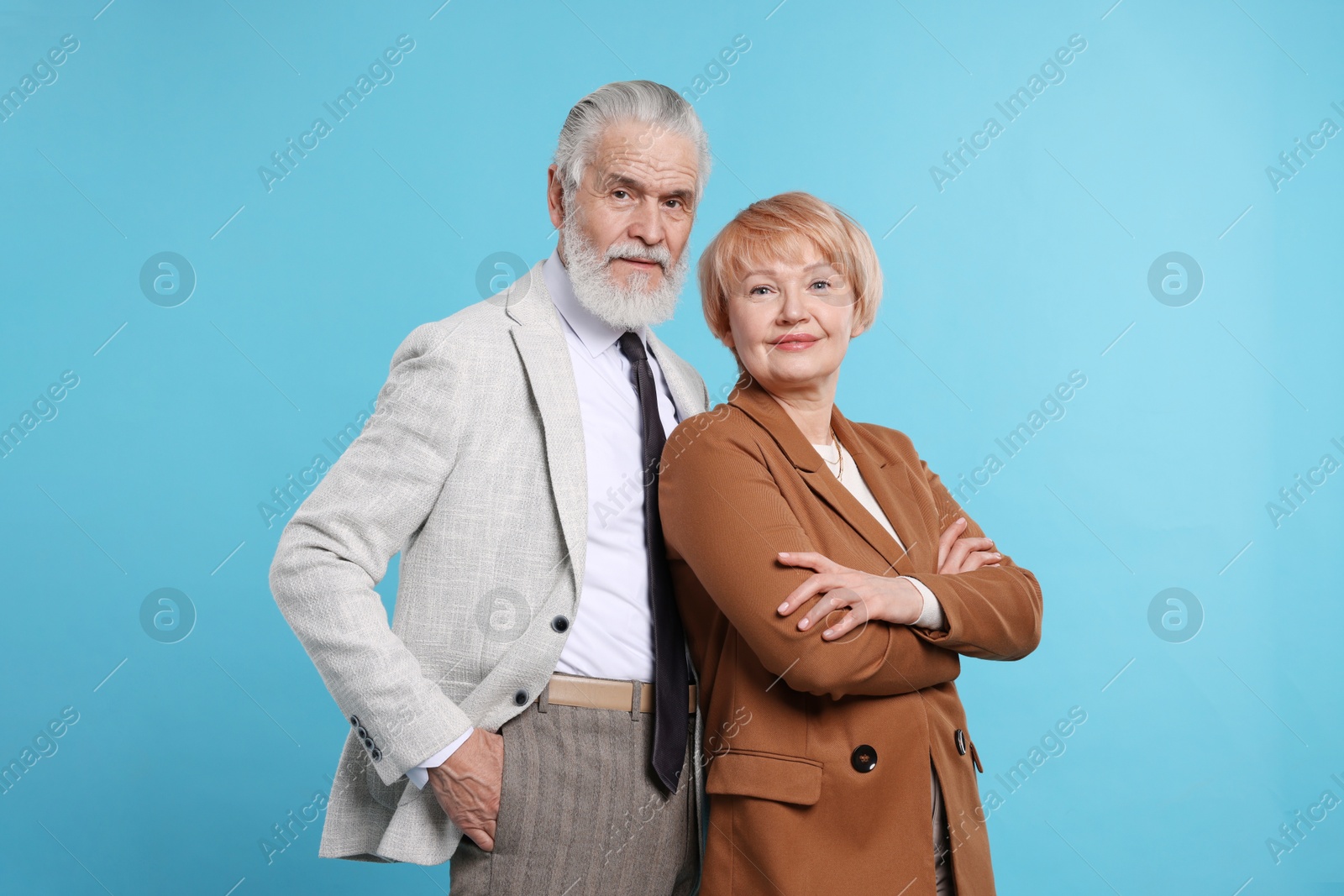 Photo of Portrait of lovely senior couple on light blue background