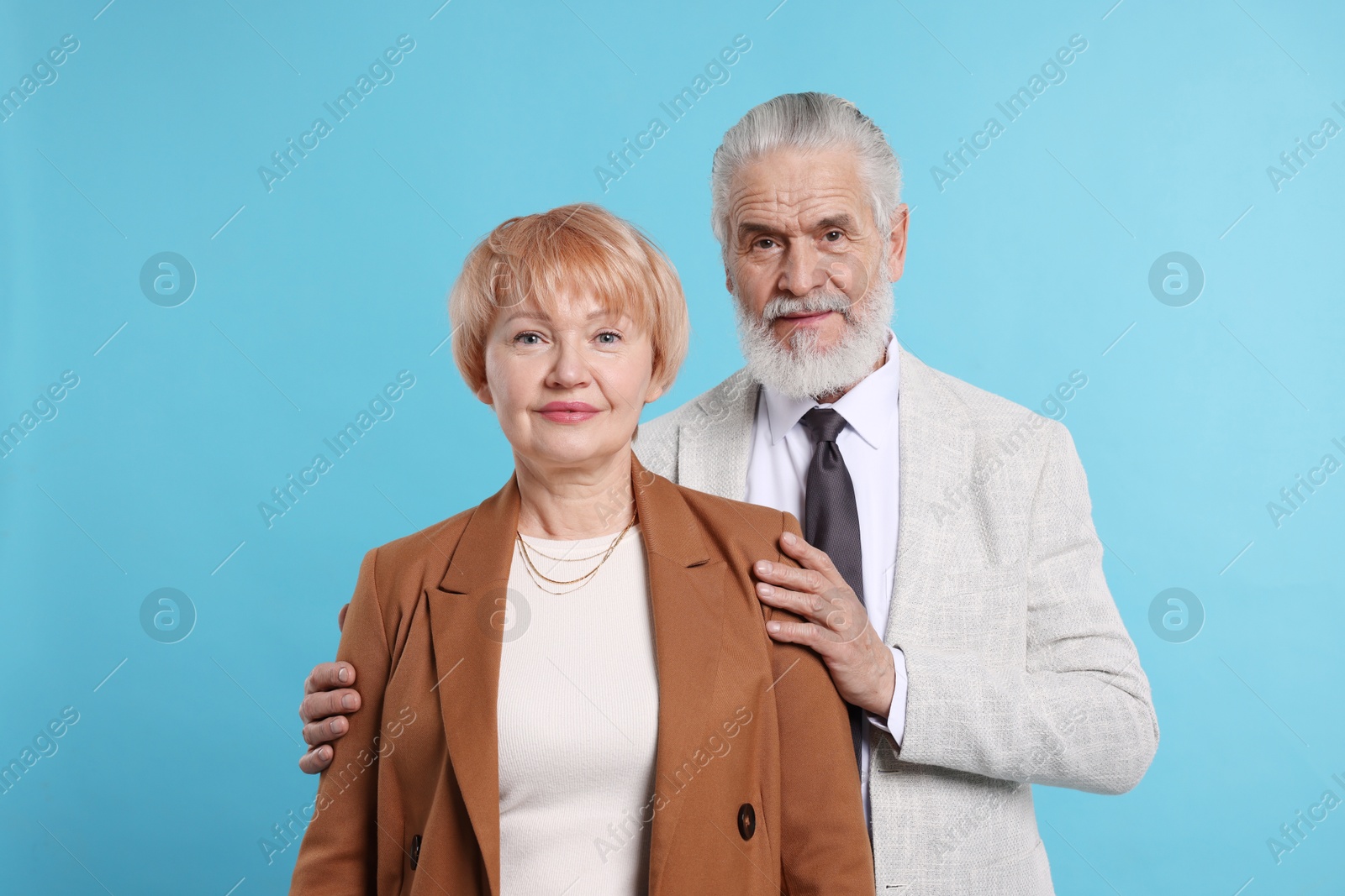 Photo of Portrait of lovely senior couple on light blue background