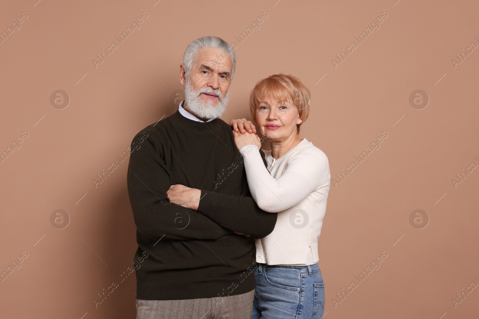 Photo of Portrait of lovely senior couple on beige background