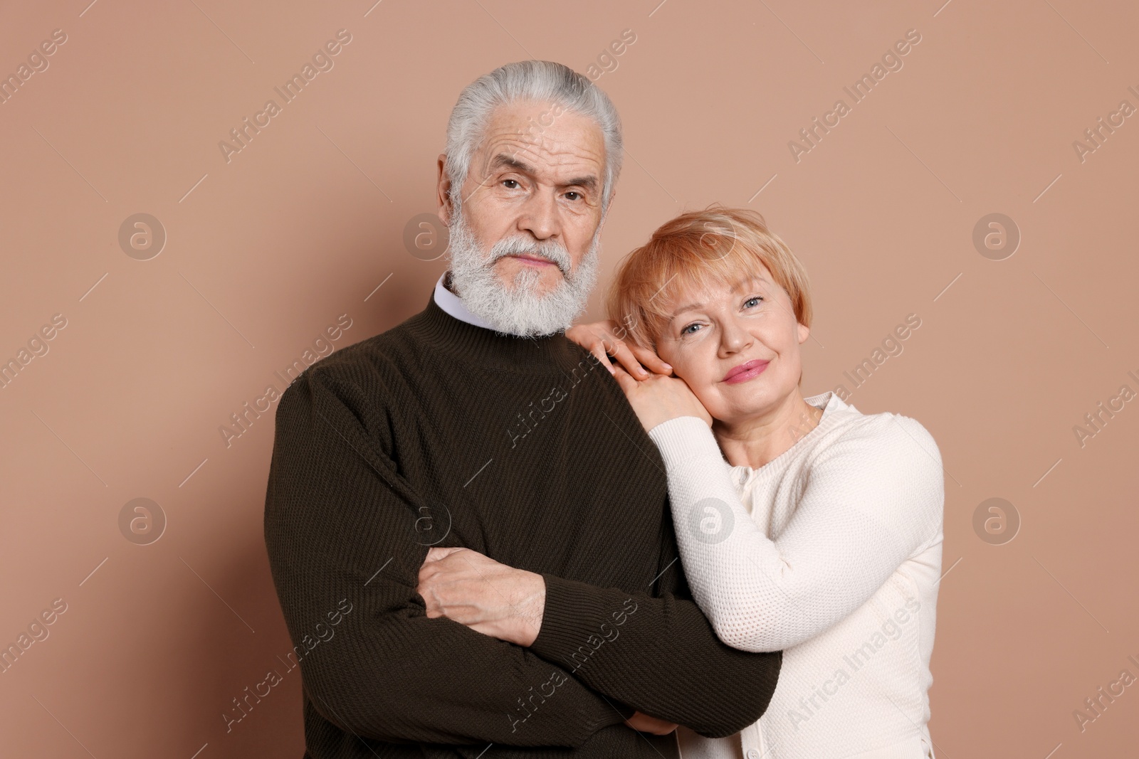 Photo of Portrait of lovely senior couple on beige background