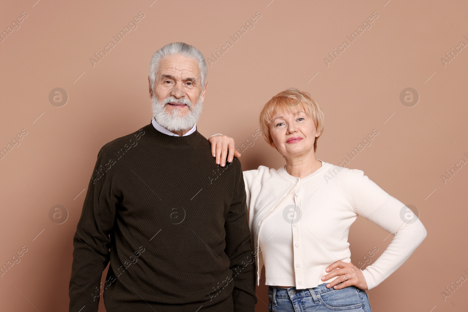 Photo of Portrait of lovely senior couple on beige background