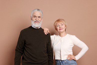 Portrait of lovely senior couple on beige background