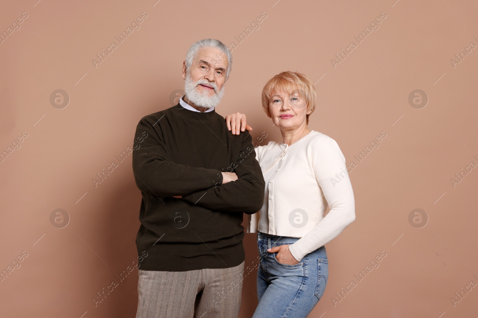 Photo of Portrait of lovely senior couple on beige background