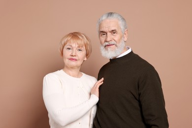 Photo of Portrait of lovely senior couple on beige background