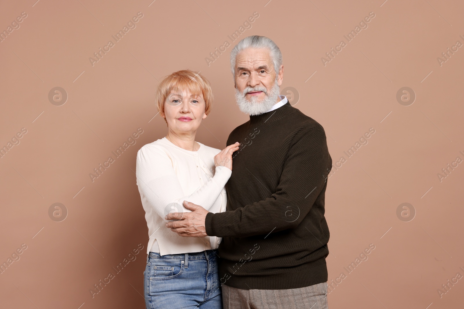 Photo of Portrait of lovely senior couple on beige background