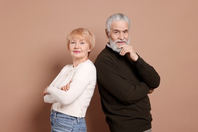 Photo of Portrait of lovely senior couple on beige background