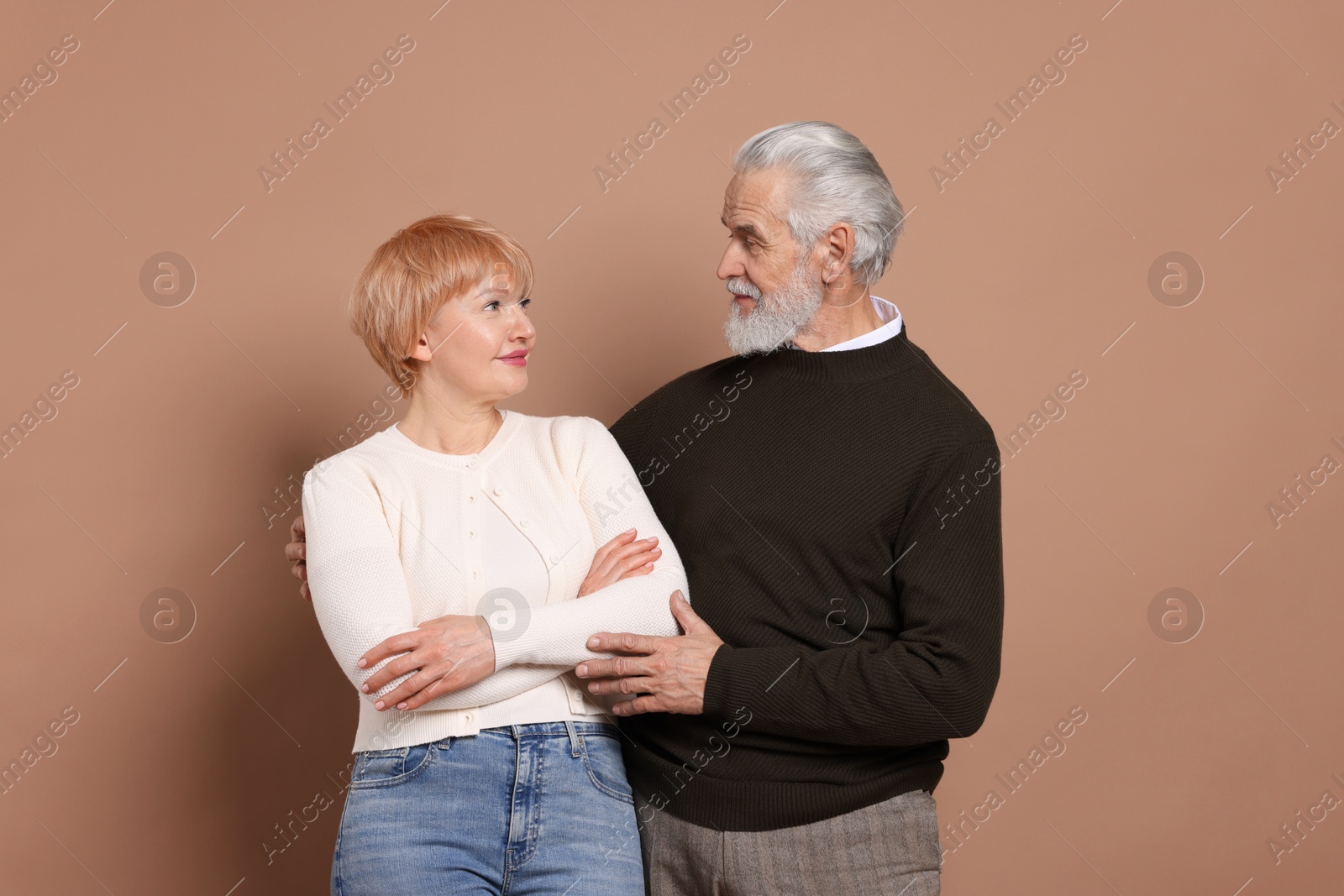 Photo of Portrait of lovely senior couple on beige background