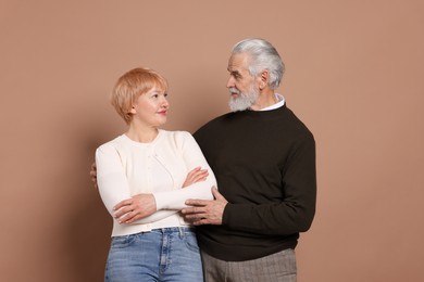 Photo of Portrait of lovely senior couple on beige background