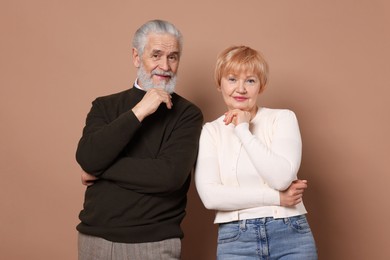 Photo of Portrait of lovely senior couple on beige background