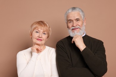 Photo of Portrait of lovely senior couple on beige background