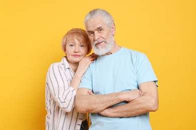 Photo of Portrait of lovely senior couple on orange background