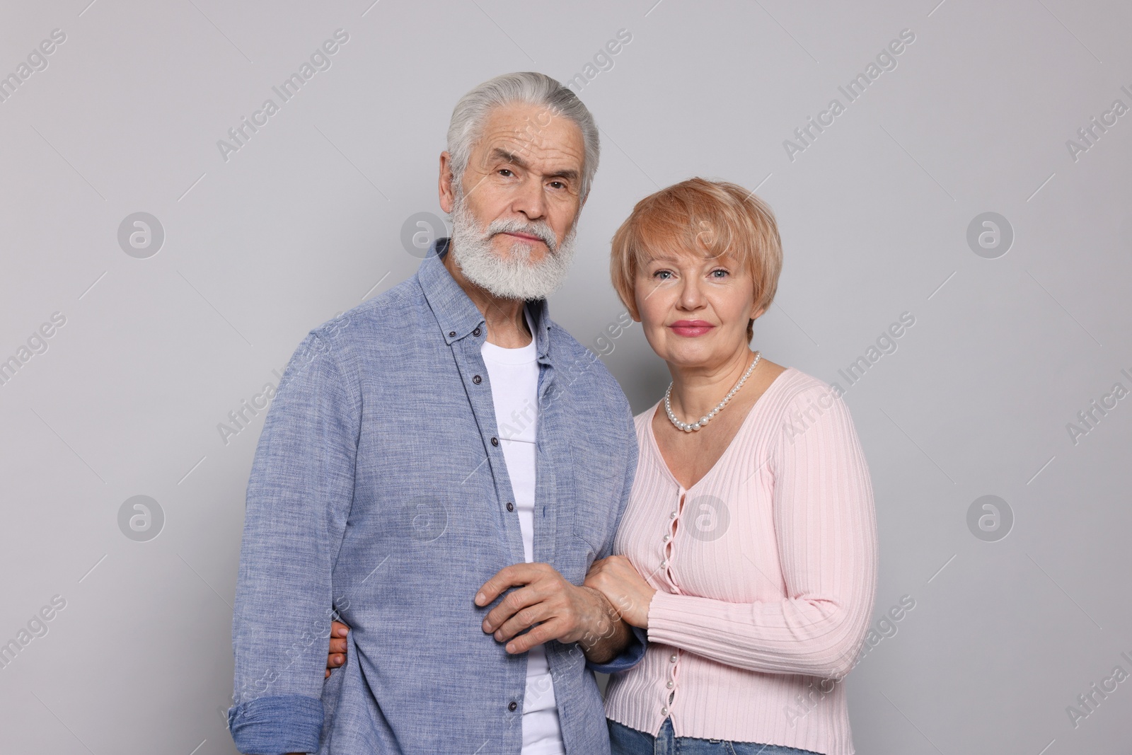 Photo of Portrait of lovely senior couple on grey background