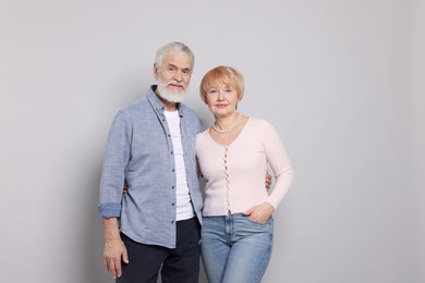 Photo of Portrait of lovely senior couple on grey background