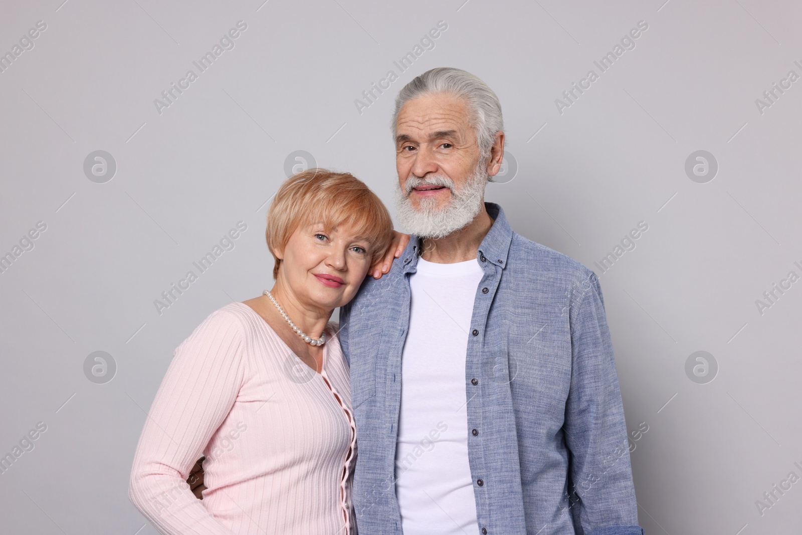 Photo of Portrait of lovely senior couple on grey background