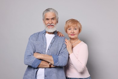 Photo of Portrait of lovely senior couple on grey background