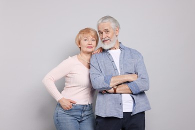 Portrait of lovely senior couple on grey background