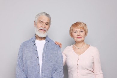 Photo of Portrait of lovely senior couple on grey background