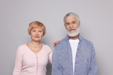 Photo of Portrait of lovely senior couple on grey background