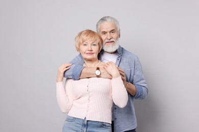 Photo of Portrait of lovely senior couple on grey background