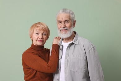 Photo of Portrait of lovely senior couple on green background