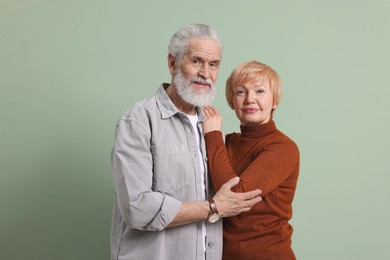 Photo of Portrait of lovely senior couple on green background