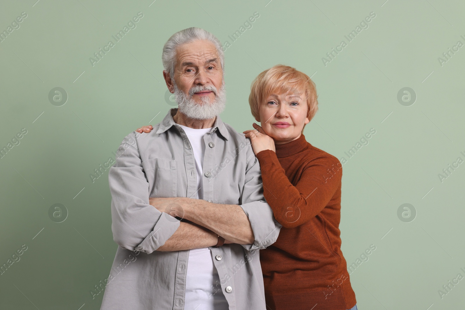 Photo of Portrait of lovely senior couple on green background