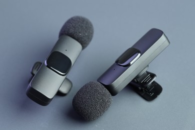 Photo of Lavalier microphones on light grey background, closeup