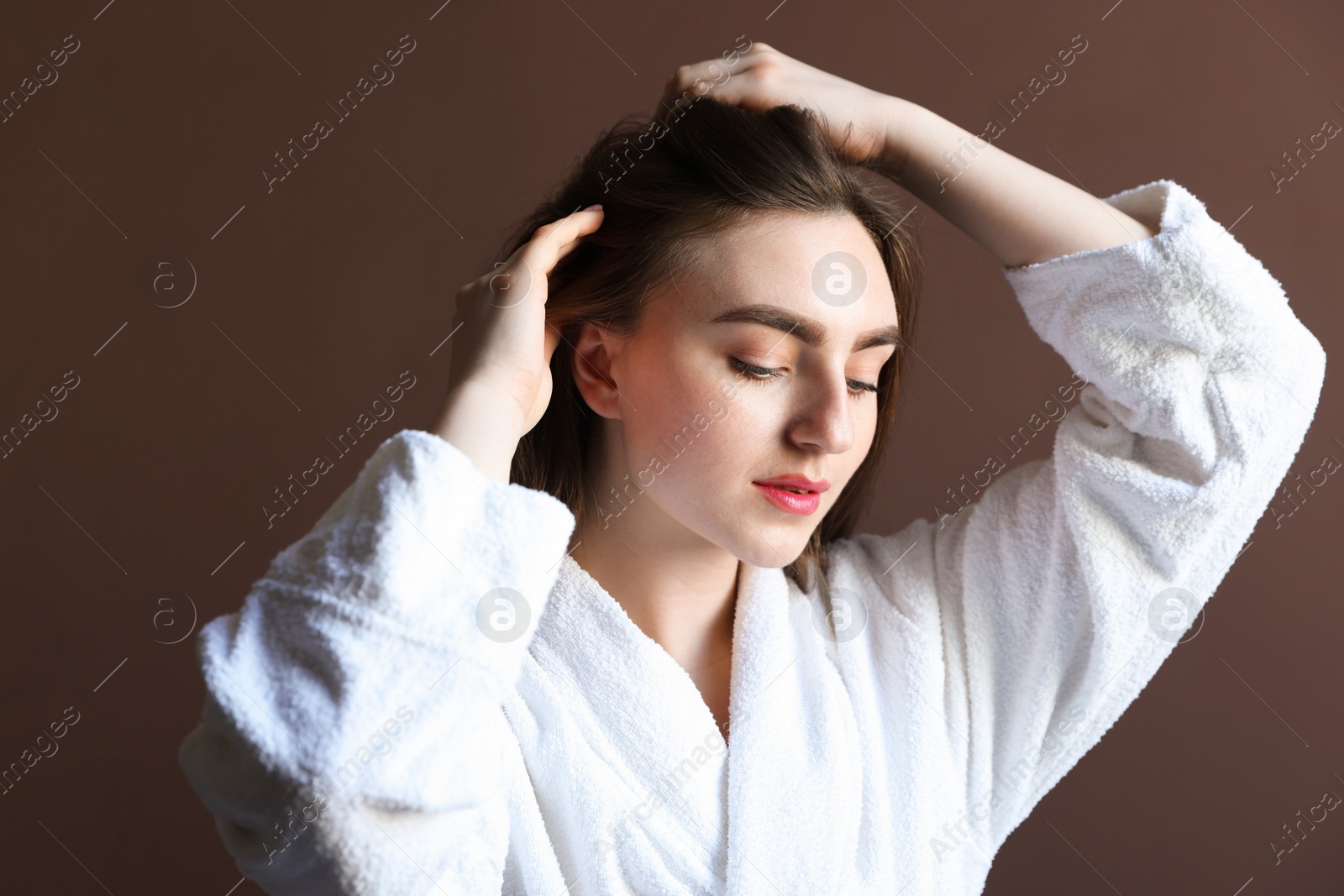 Photo of Beautiful woman with healthy hair roots on brown background