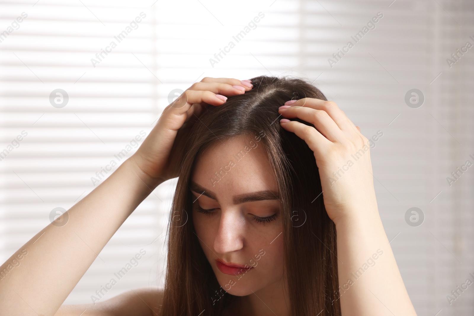 Photo of Beautiful woman with healthy hair roots at home