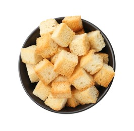 Photo of Delicious crispy croutons in bowl isolated on white, top view