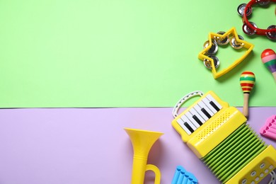 Photo of Different toy musical instruments on color background, flat lay. Space for text