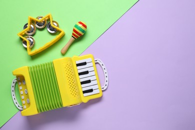 Photo of Different toy musical instruments on color background, flat lay. Space for text