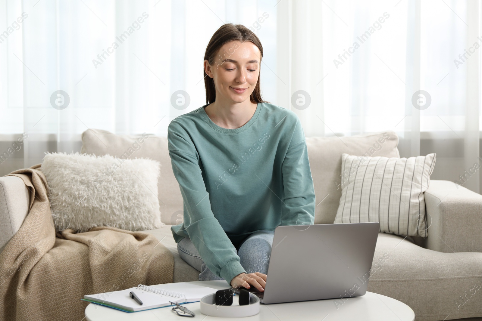 Photo of Woman learning online using laptop at table indoors. Self-study