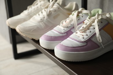 Photo of Shoe storage. Shelving unit with different footwear indoors, closeup