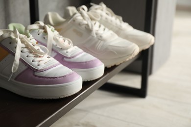 Photo of Shoe storage. Shelving unit with different footwear indoors, closeup