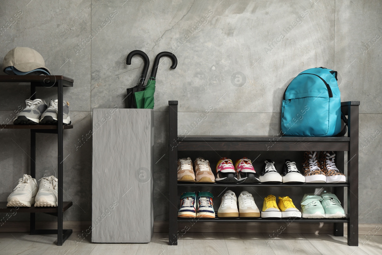 Shoe storage bench with different footwear and other accessories indoors Photo of Shoe storage bench with different footwear and other accessories indoors
