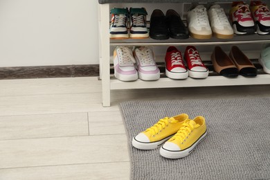 Photo of Shoe storage bench with different footwear indoors, space for text