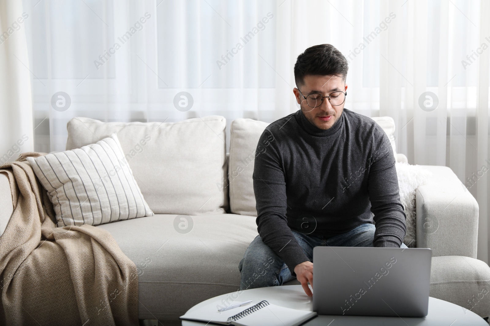 Photo of Man learning online using laptop at table indoors, space for text. Self-study