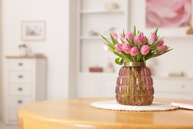 Photo of Bouquet of beautiful tulips in vase on table indoors, space for text