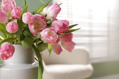 Photo of Bouquet of beautiful tulips in vase indoors, closeup. Space for text