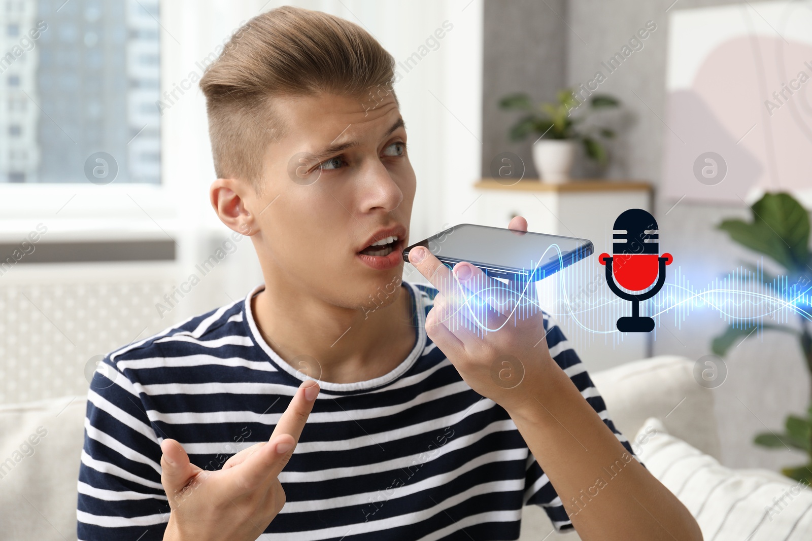 Image of Young man recording voice message via smartphone at home. Illustration of microphone and sound waves