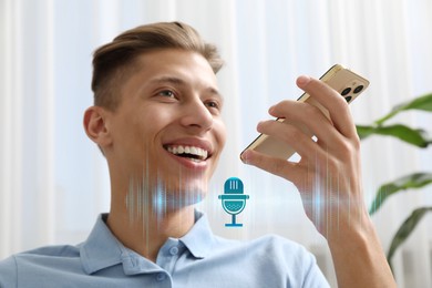 Young man recording voice message via smartphone at home. Illustration of microphone and sound waves