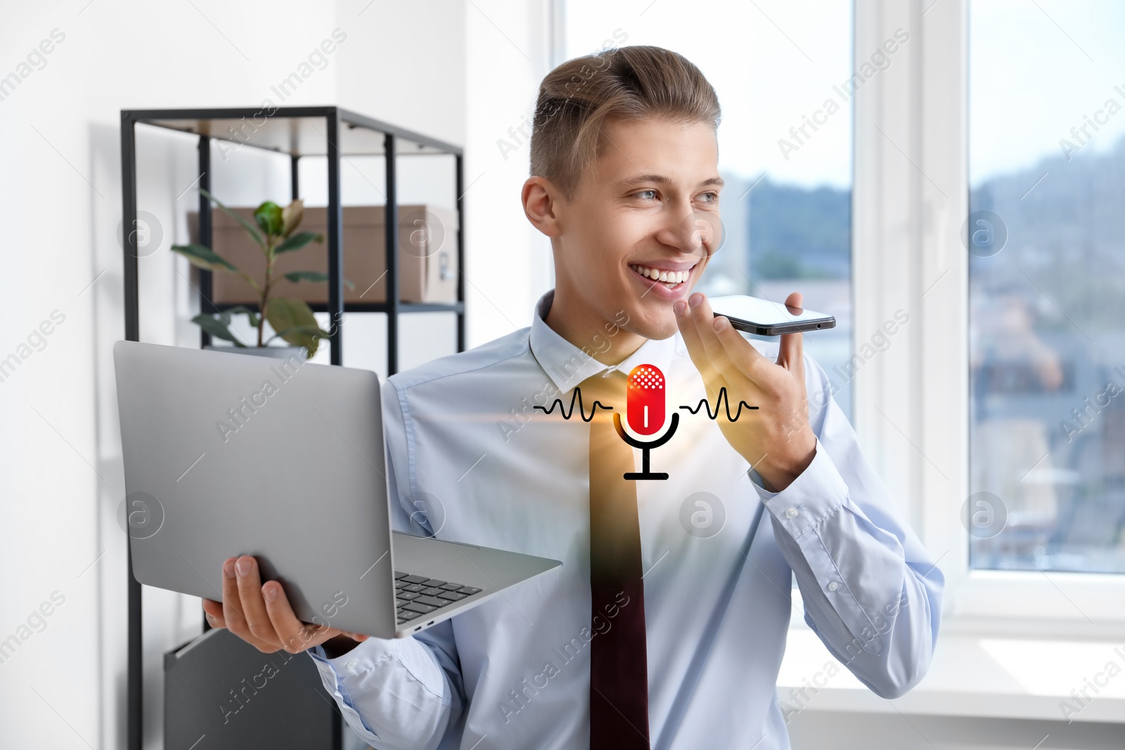 Image of Young man recording voice message via smartphone in office. Illustration of microphone and sound waves