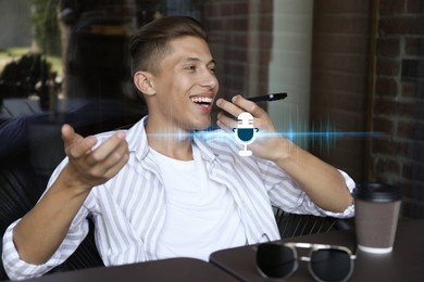 Young man recording voice message via smartphone in cafe. Illustration of microphone and sound waves