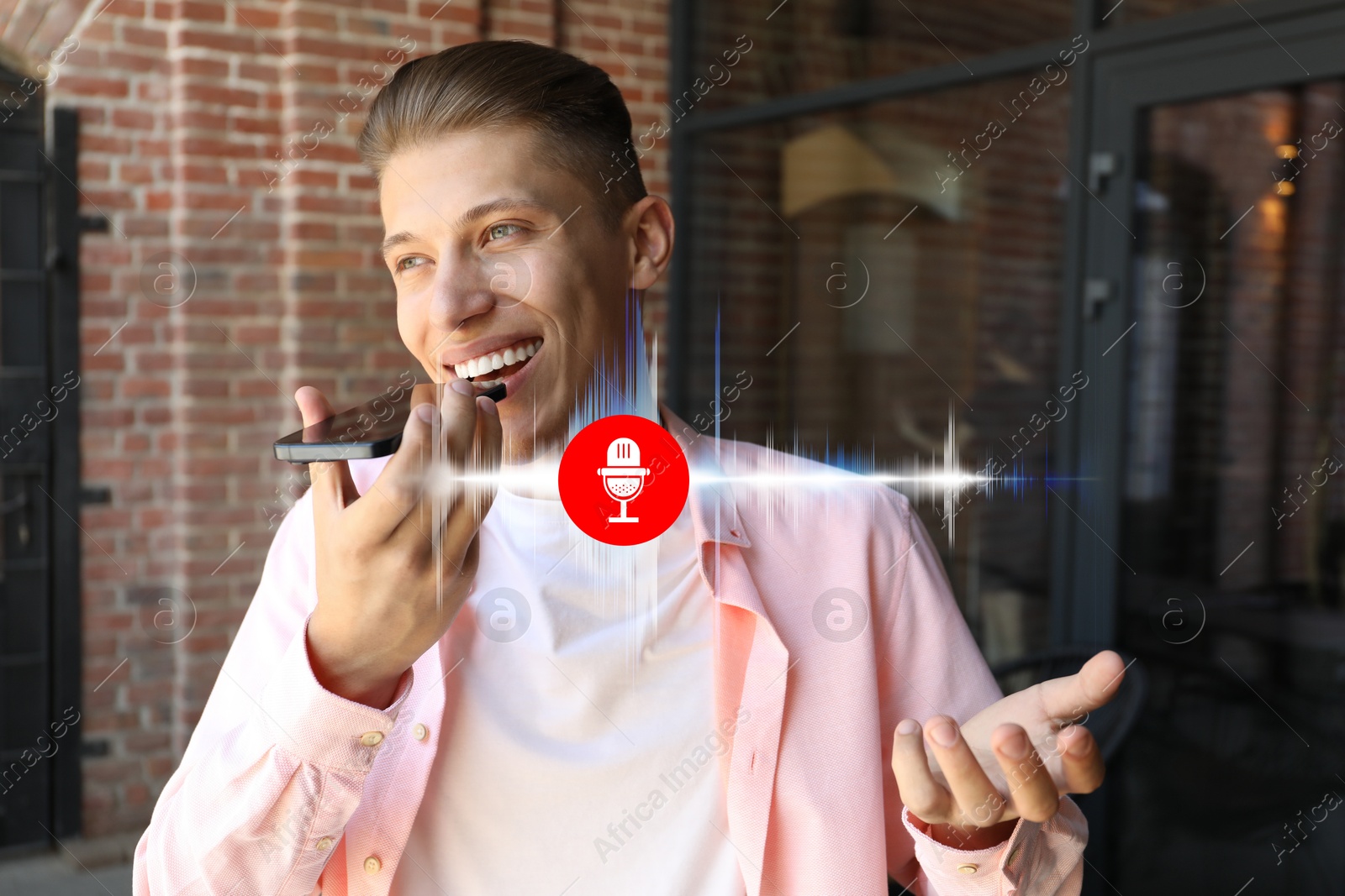 Image of Young man recording voice message via smartphone outdoors. Illustration of microphone and sound waves