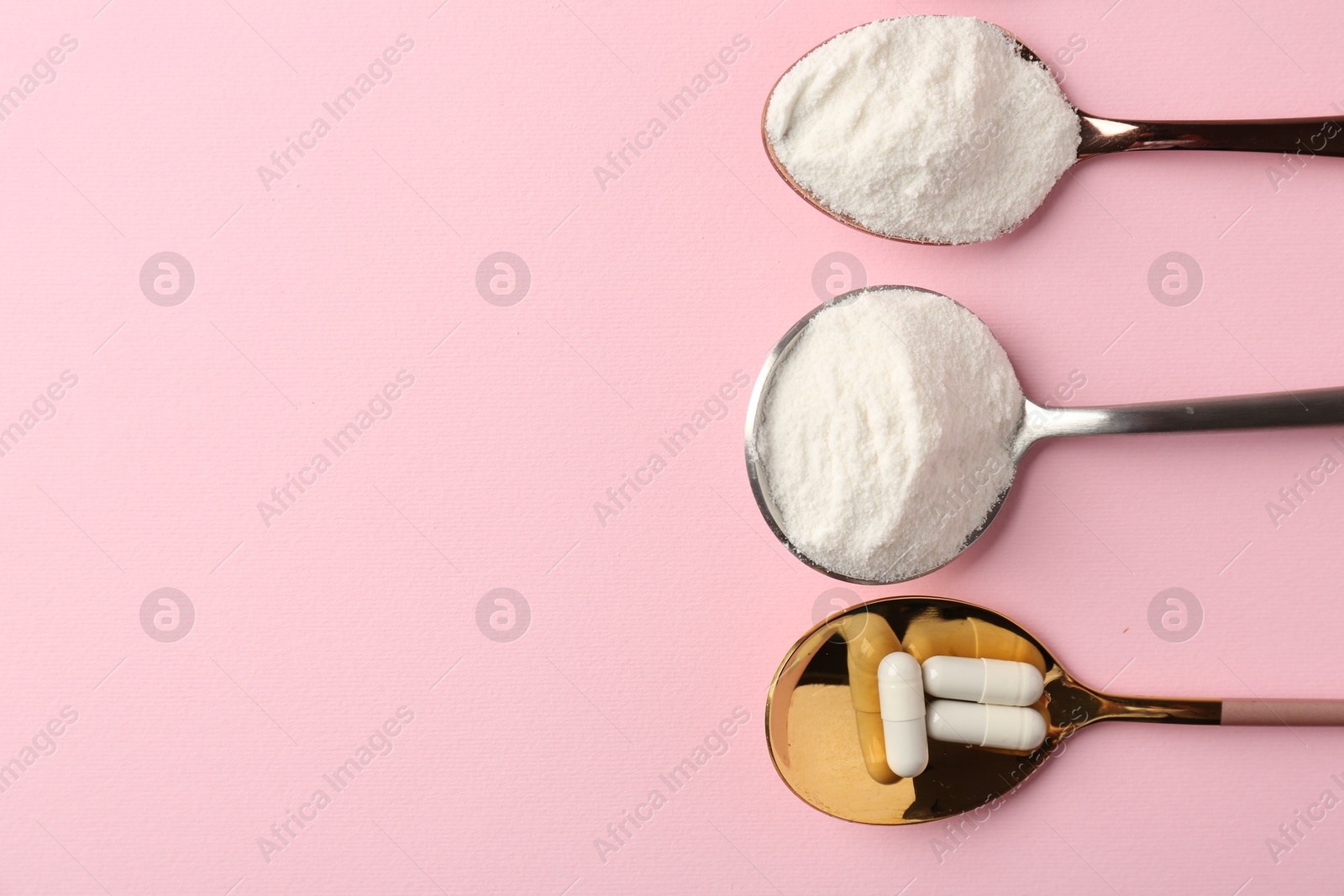 Collagen powder and pills on pink background, flat lay. Space for text Photo of Collagen powder and pills on pink background, flat lay. Space for text